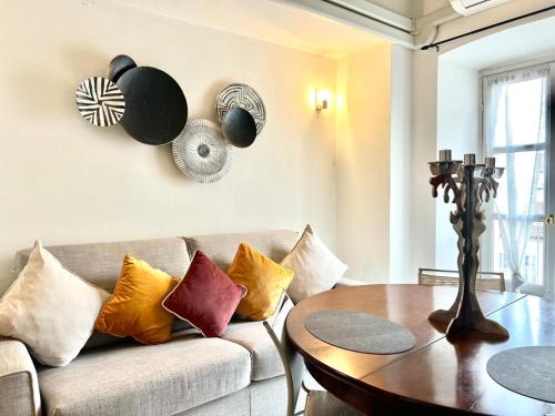 a living room with a couch and a wooden table at ComeCasa Alfieri Elegant Apartment in Asti