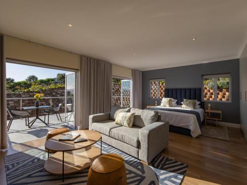 a living room with a bed and a couch at Pincushion Heights in Brenton-on-Sea