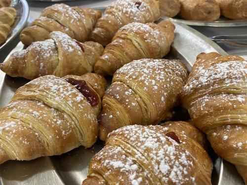 a bunch of pastries sitting on a tray at Hotel Nanni Garnì in Rimini