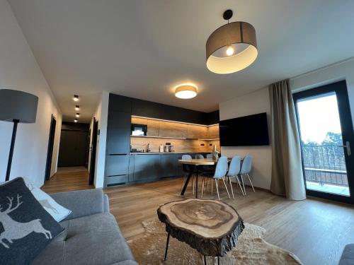 a living room with a couch and a table at BlackDEER Apartment Liptov in Liptovský Mikuláš