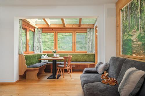 a living room with a couch and a table at Hörandlhof in Aigen im Ennstal