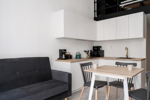 a living room with a couch and a table at RentPlanet - Apartamenty Zarembowicza in Wrocław