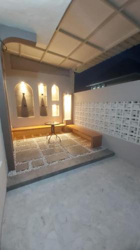 a room with a table and a lamp in it at Kavilla2 Regency in Karangploso