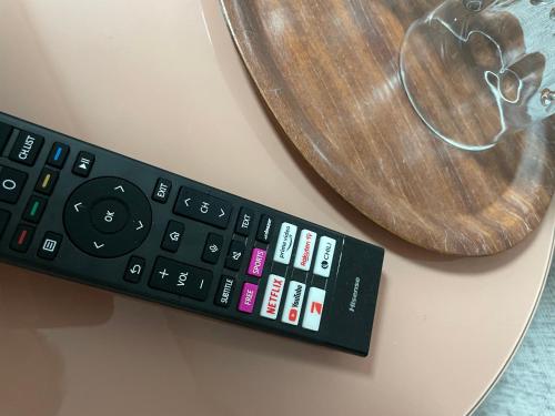 a remote control on a table next to a wooden plate at Cochemer Arkaden in Cochem