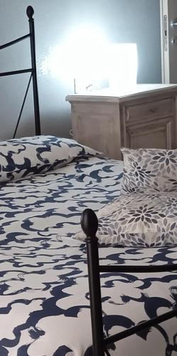 a bedroom with a bed with a black and white comforter at Margot Ca Bianca Dormelletto Lago Maggiore in Dormelletto