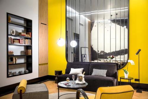 a living room with a couch and a table at Century Old Town Prague - MGallery Collection in Prague