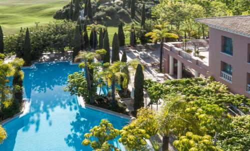 an overhead view of a pool with trees and a building at Anantara Villas & Suites Marbella Benahavis in Estepona