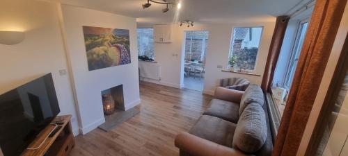 a living room with a couch and a fireplace at Cherry Croft in Wigton