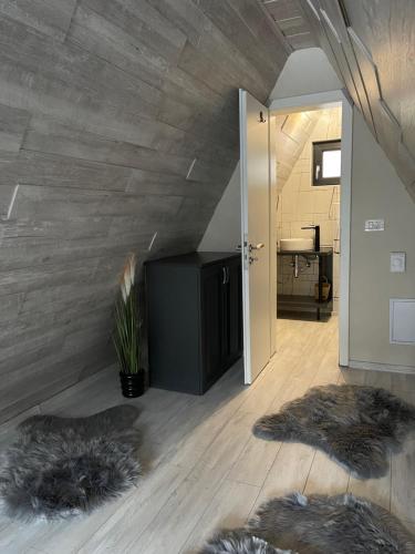 a living room with fur pillows on the floor at Valea Mosului - Cozy A Frame in Petroşani