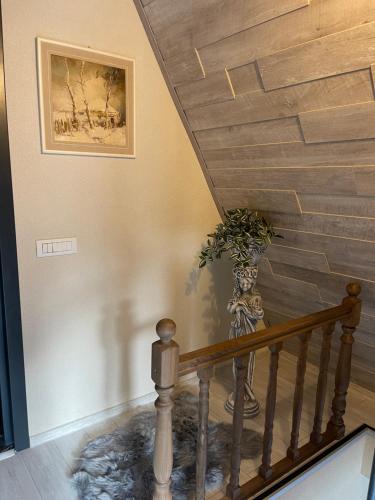 a staircase with a vase with a plant in it at Valea Mosului - Cozy A Frame in Petroşani