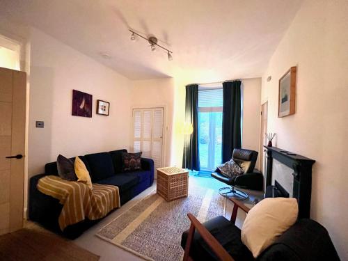 a living room with a couch and a chair at Garden Flat in Edinburgh