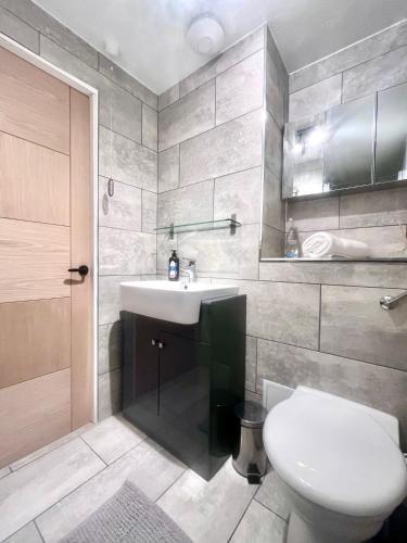 a bathroom with a white sink and a toilet at Garden Flat in Edinburgh