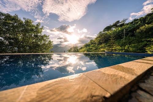 a swimming pool with the sky in the water at Awesome Place in Ella