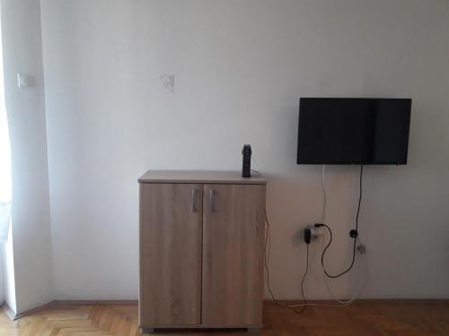 a small cabinet with a television on a wall at Apartman in Trebinje