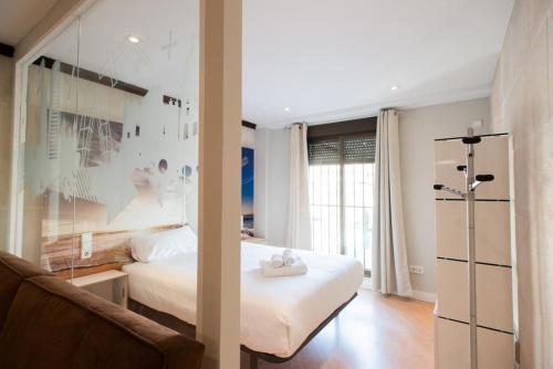 a bedroom with a bed and a couch in a room at Homelikes Madrid in Madrid