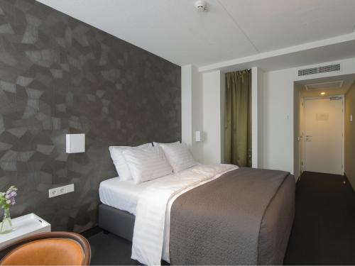 Ένα ή περισσότερα κρεβάτια σε δωμάτιο στο Hotel Mauritz