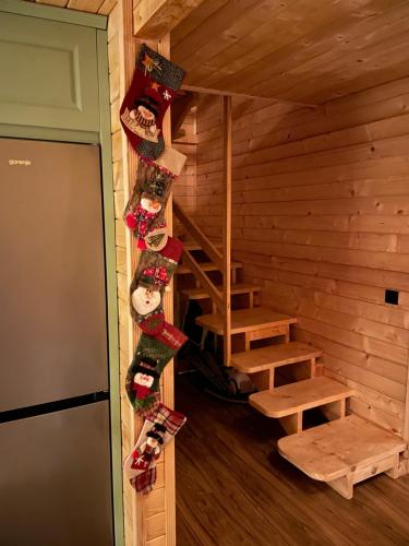an attic room with stairs in a log cabin at Shpija e Liqenit in Pristina