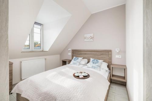 Ένα ή περισσότερα κρεβάτια σε δωμάτιο στο Apartamenty przy Plaży - Promenada Mielno by Noclegi Renters
