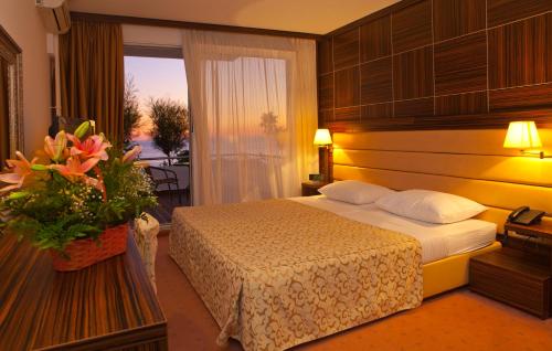 a hotel room with a bed and a window at Hotel Palas in Petrovac na Moru