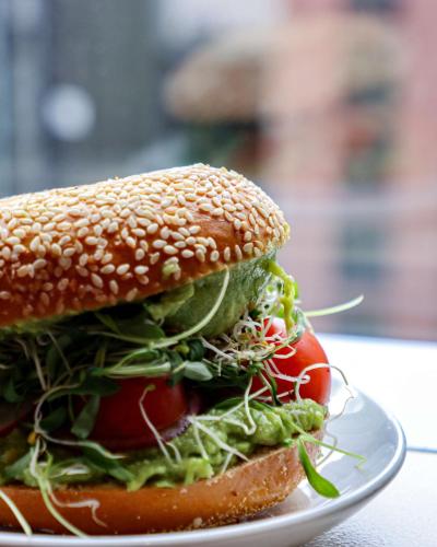 a sandwich with lettuce and tomatoes on a plate at Hyatt at Olive 8 in Seattle