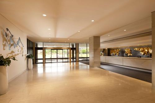 a large room with a lobby with a large display of artifacts at Hilton Adelaide in Adelaide