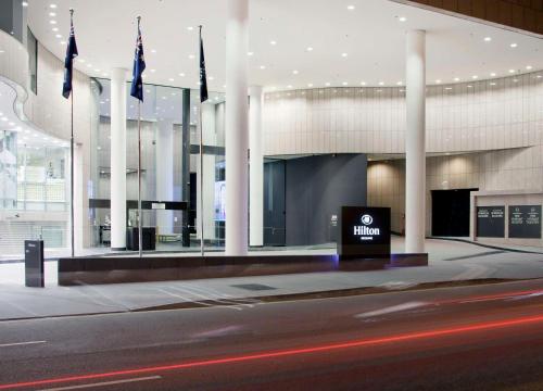 a building with a sign in front of it at Hilton Brisbane in Brisbane