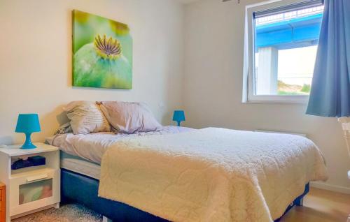 a bedroom with a bed and a window at Duin en zee in Bredene