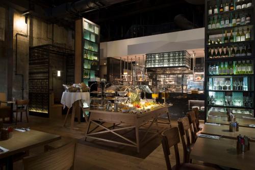 a restaurant with a table and chairs and bottles at DoubleTree by Hilton Melbourne in Melbourne