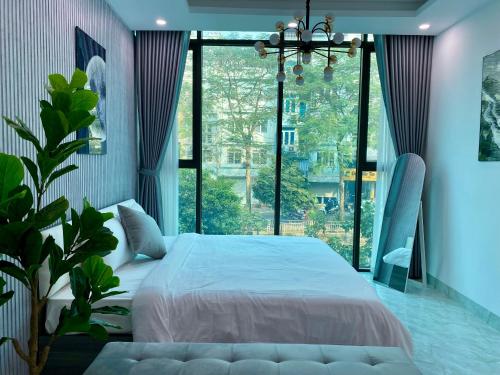 a bedroom with a large bed and a large window at Lightning Riverside in Hanoi