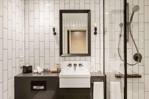 a bathroom with a sink and a mirror at DoubleTree by Hilton Melbourne in Melbourne