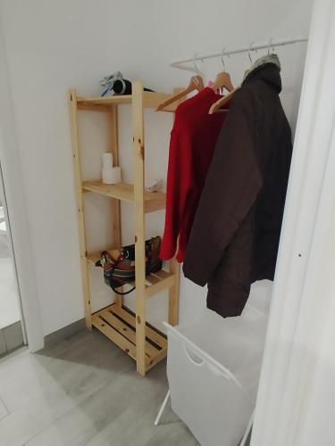 a walk in closet with clothes and shoes at La casa di Teresa in Taranto
