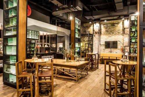a restaurant with wooden tables and chairs and a tv at DoubleTree by Hilton Melbourne in Melbourne