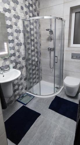 a bathroom with a shower and a toilet and a sink at Fairwinds - Double Room with Ensuite - Luqa Airport - Self Check In & Out available in Luqa