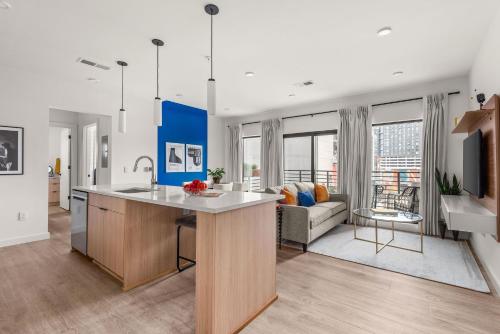 an open kitchen and living room with a couch at Hyve in Nashville