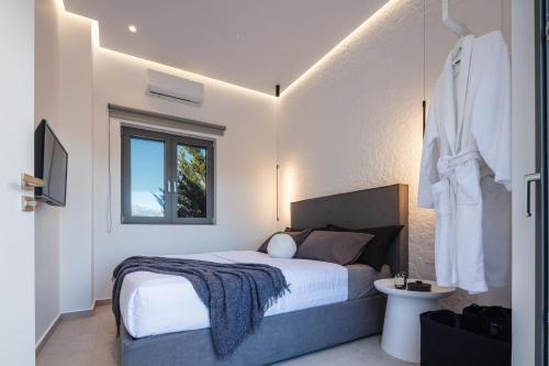 a bedroom with a bed and a window at Akonizia Luxury House - With Private Swimming Pool in Dhrámia