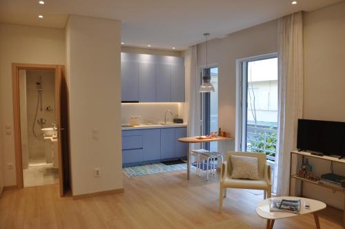 a living room with a kitchen and a bathroom at Athens Sea Front Apartment - Athenian Riviera in Varkiza