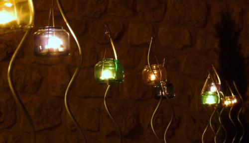 a group of lights hanging on a wall at Eco Hotel Boutique & Spa Capitulo Trece - Adults Only in Maderuelo