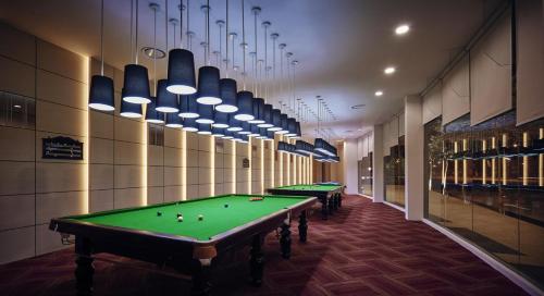 a row of pool tables in a billiard room at Ninja's Sweet Home in Seremban