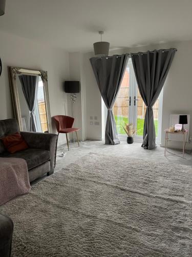 a living room with black curtains and a couch at Walsall New Large House with Garden in Pelsall
