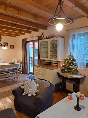un soggiorno con un divano e un tavolo con un albero di Natale di Vikendica Vil a Blidinje