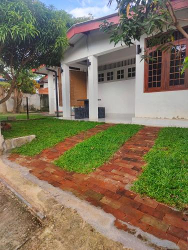 a brick walkway in front of a building at Araliya Uyana Residencies Colombo - Entire House with Two Bedrooms in Colombo