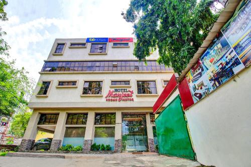 a tall building with a green door in front of it at FabHotel Prime Manjeet in Bhopal