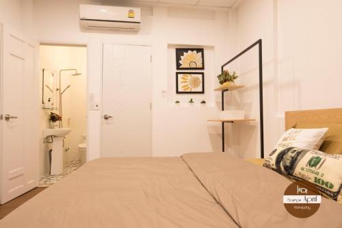 Ένα ή περισσότερα κρεβάτια σε δωμάτιο στο Saigon April Homestay