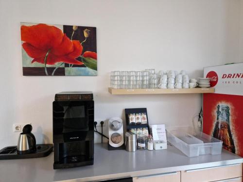 a kitchen with a counter with a microwave and a stove at Denkhaus Loccum in Rehburg-Loccum