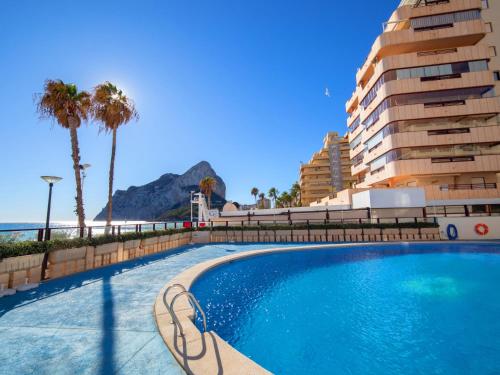 a swimming pool in front of a building and a building at Apartment Topacio I by Interhome in Calpe