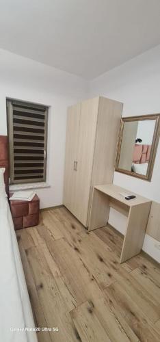 an empty room with a desk and a mirror at LukAmi Green Home in Făgăraş