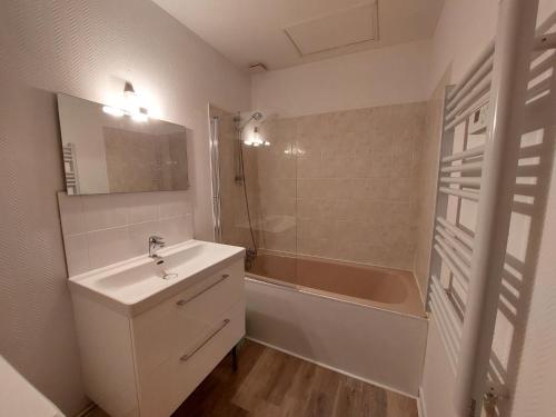 a bathroom with a sink and a bath tub at Apartment Le Petit Robinson-4 by Interhome in La Richardais