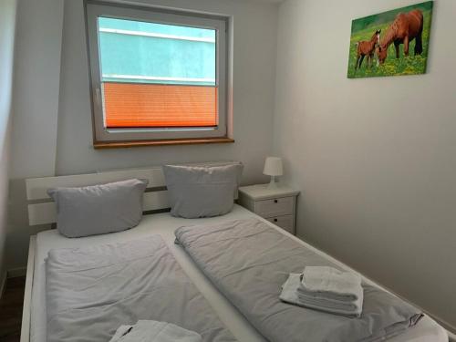 a small bedroom with a bed and a window at Immensee App D in Ehst