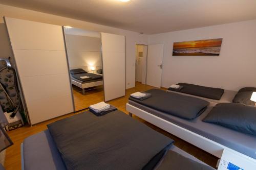 a living room with two beds and a bedroom at Apartment Dreiländereck in Rheinfelden