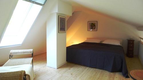 a bedroom with a large bed in a attic at Carlotta Studio in Osterhever